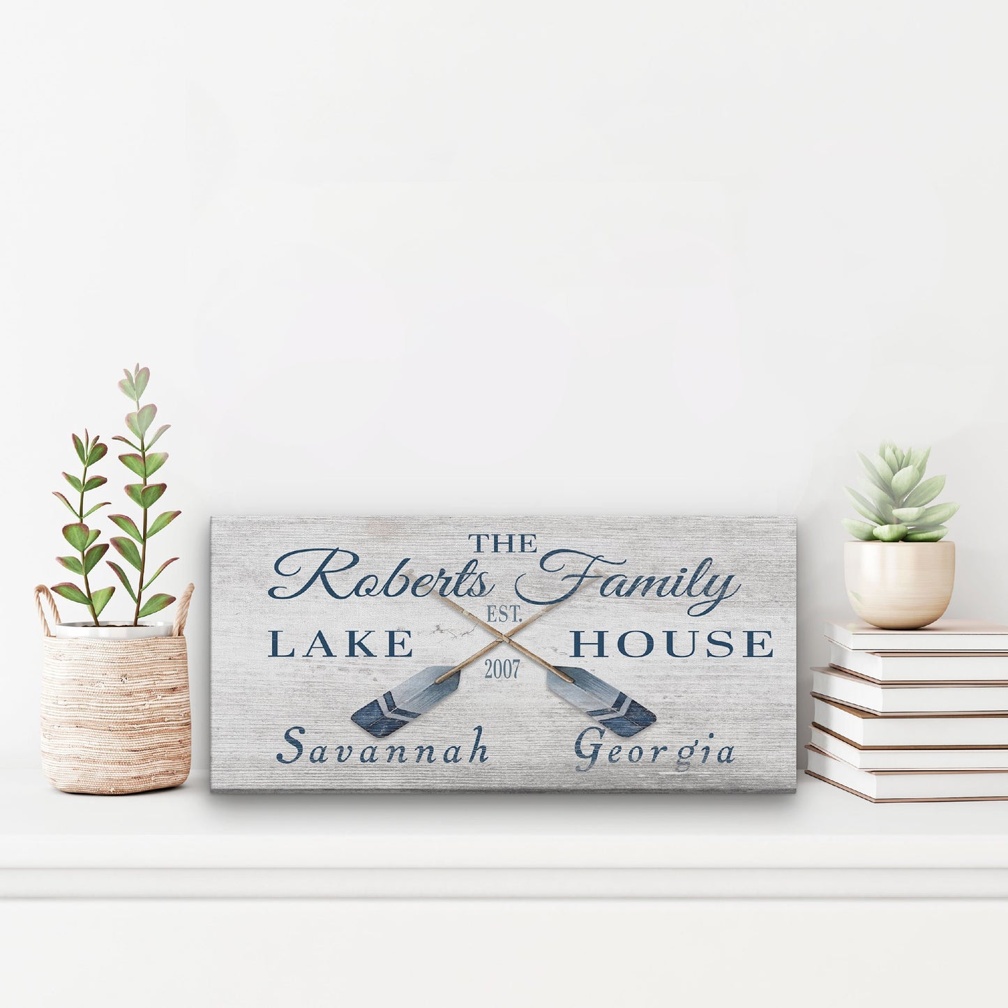 Personalized coordinates sign as statement piece above fireplace on wood mantel in coastal home