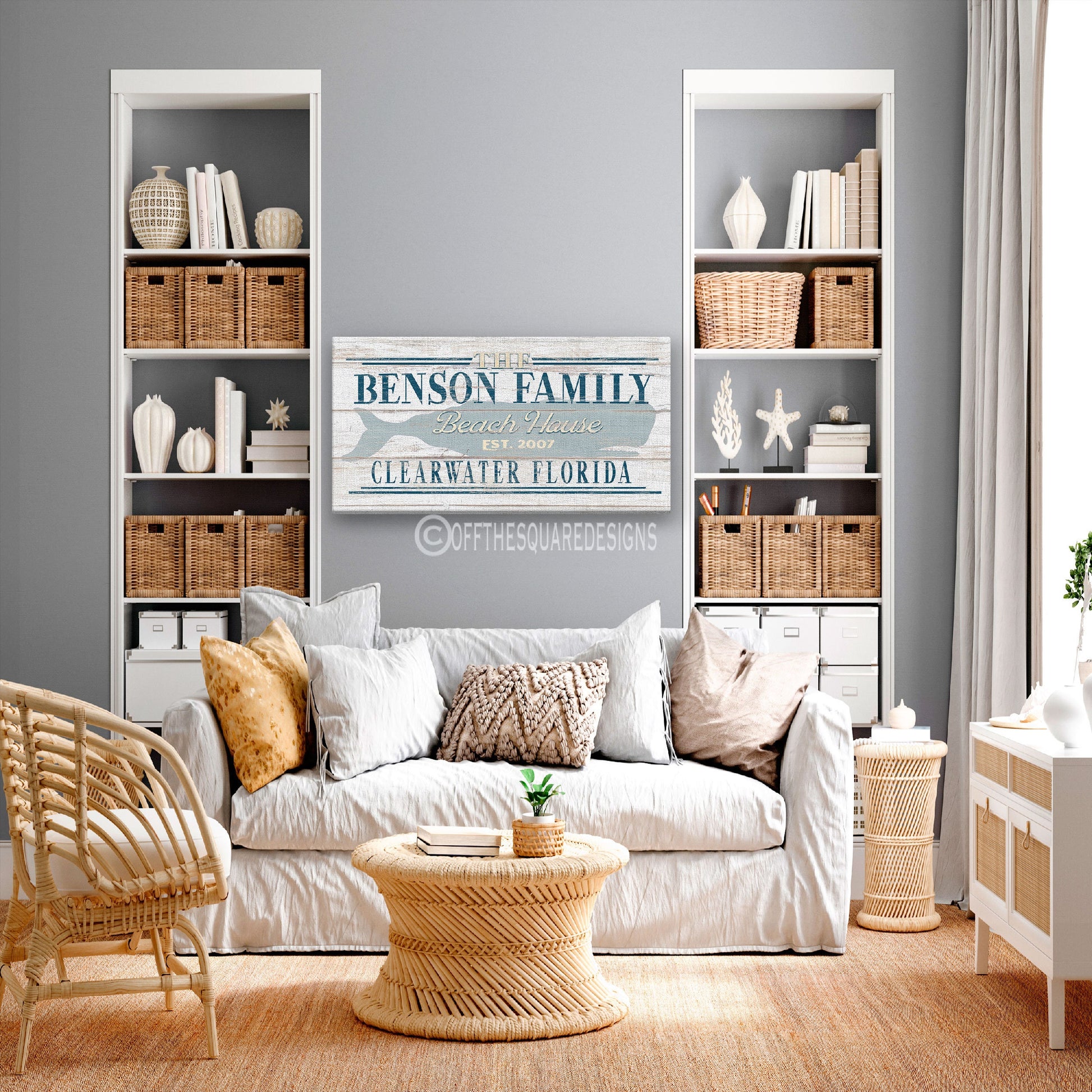 Custom family name whale sign as statement piece above wooden console table in beach house