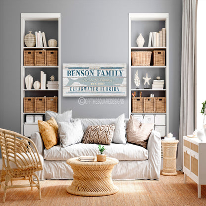 Custom family name whale sign as statement piece above wooden console table in beach house