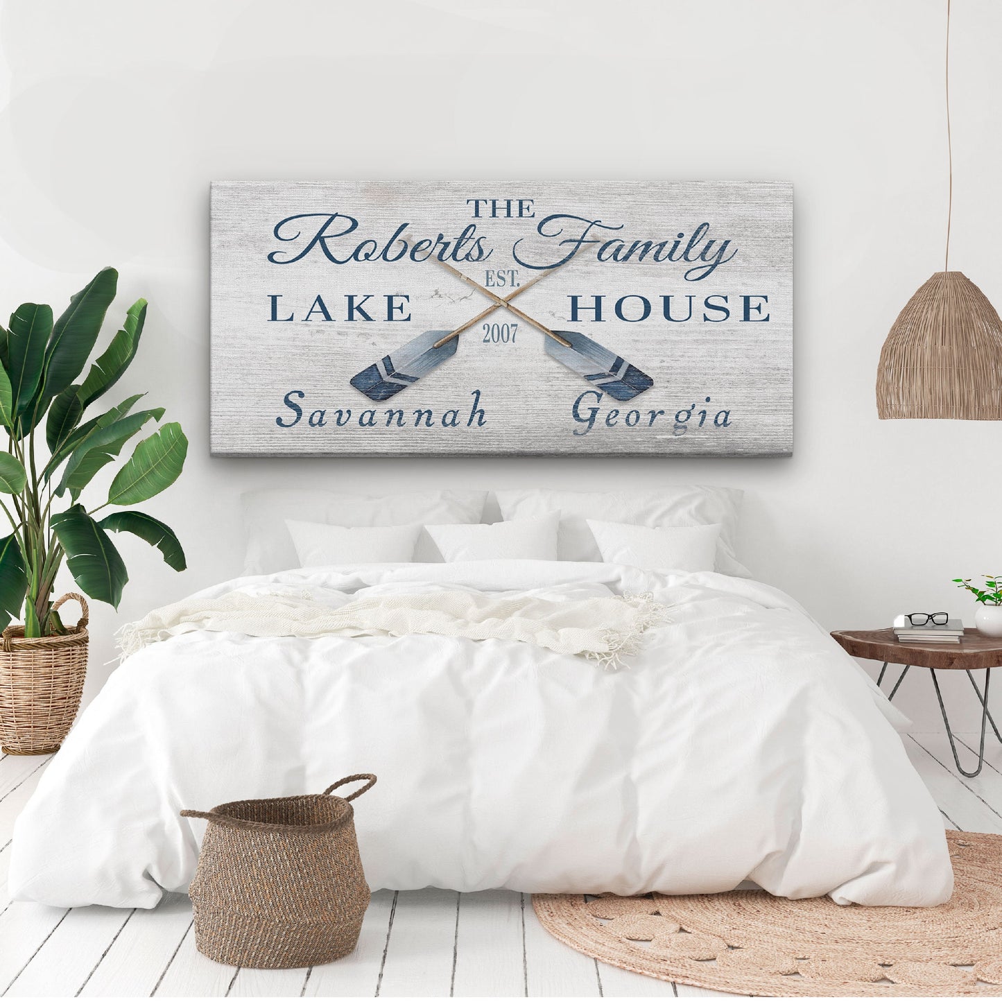 Latitude longitude oars sign displayed in den with leather furniture and masculine coastal decor