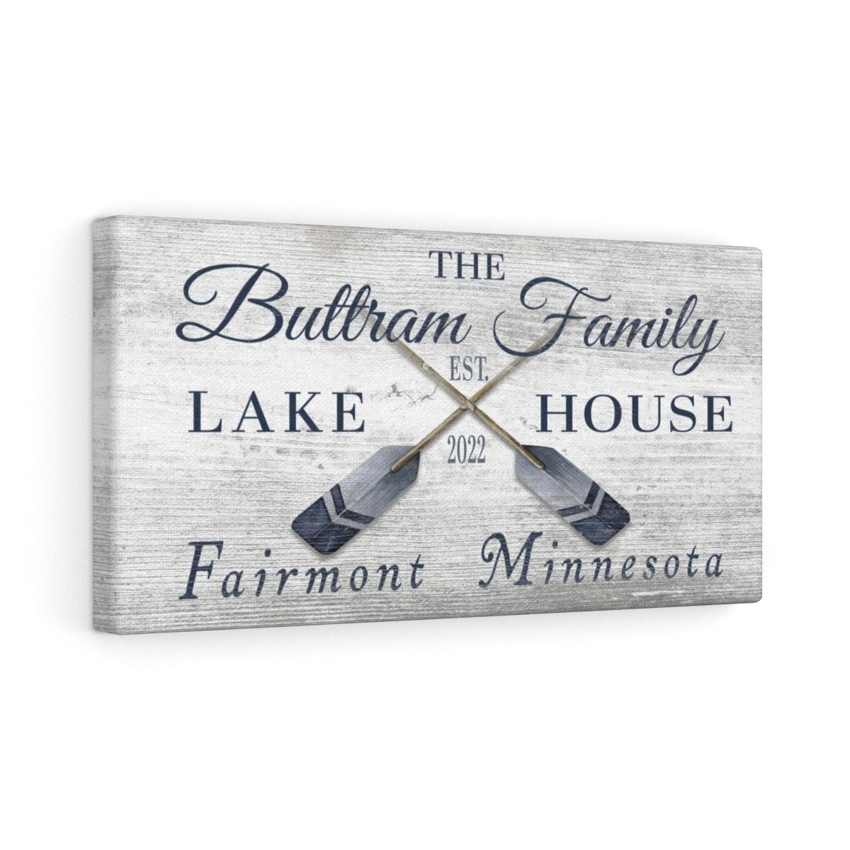 Custom coordinates sign on cabin wall with wood paneling and nautical decor accents