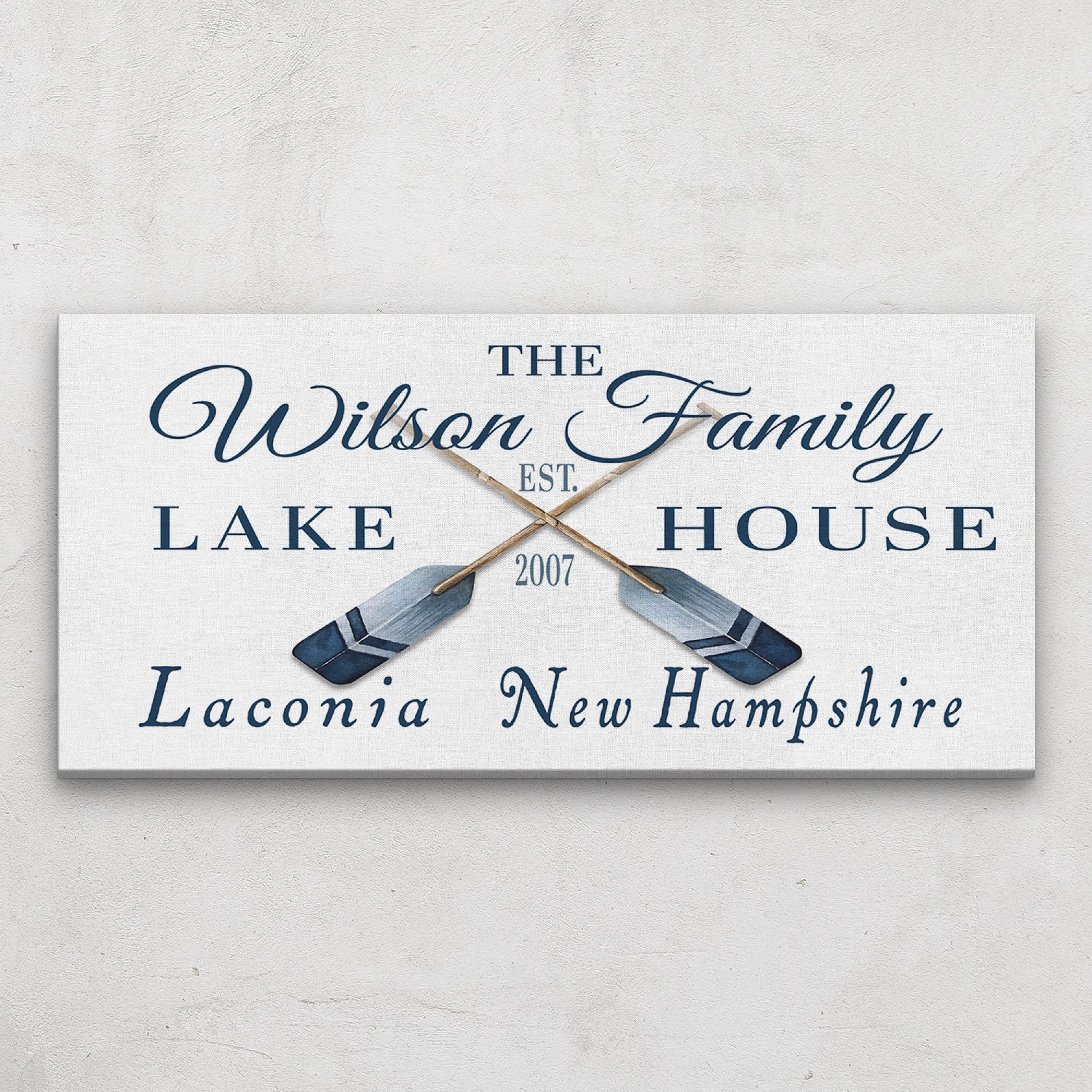 Oars and paddles coordinates sign close-up showing personalized text and rustic canvas detail