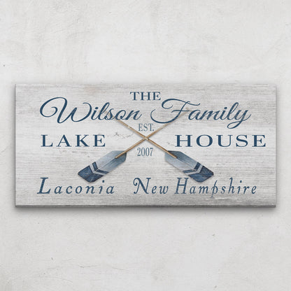 Personalized latitude longitude sign above bed in coastal bedroom with beach-inspired bedding