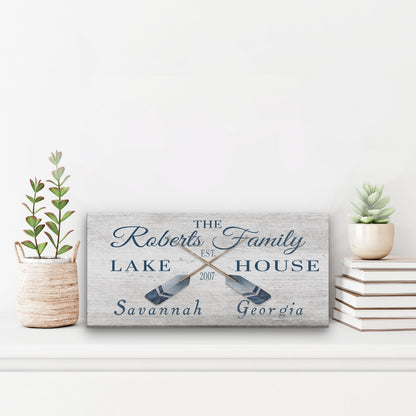 Personalized coordinates sign as statement piece above fireplace on wood mantel in coastal home