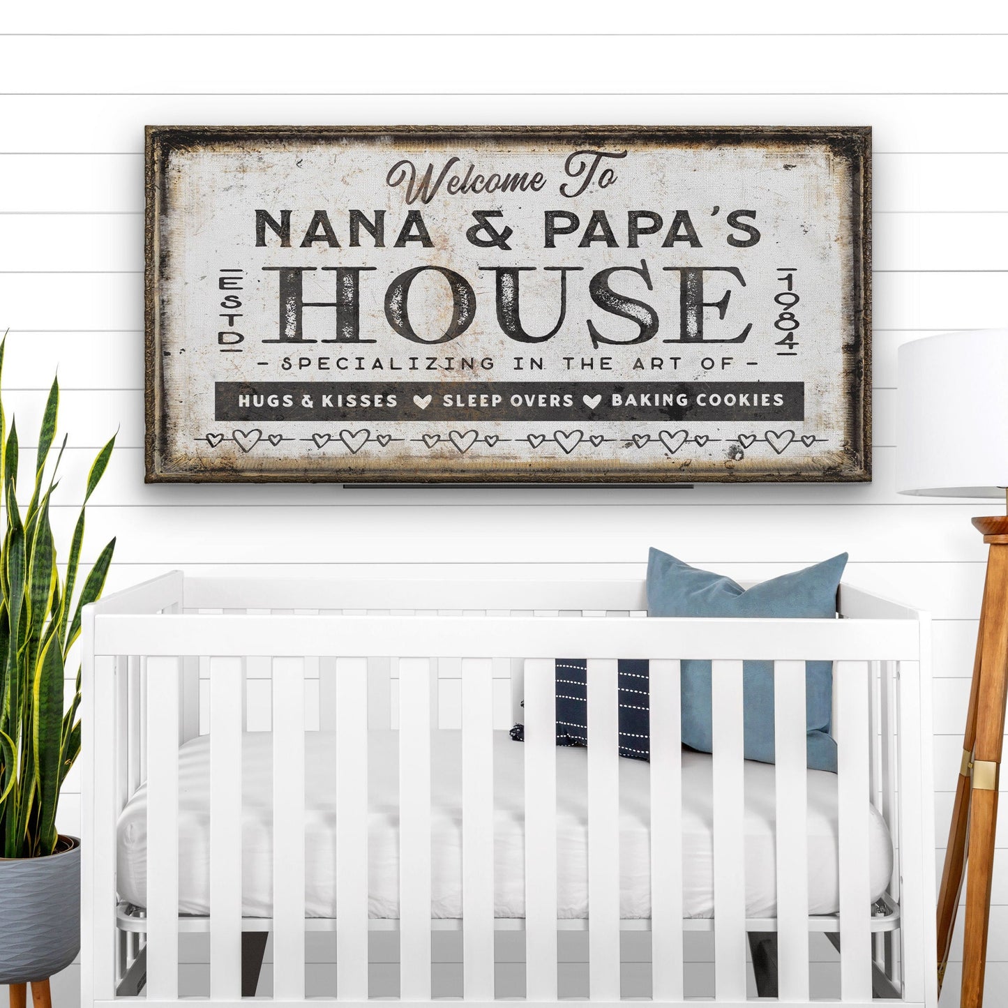 Grandparent welcome sign framed on white wall in bright living room setting