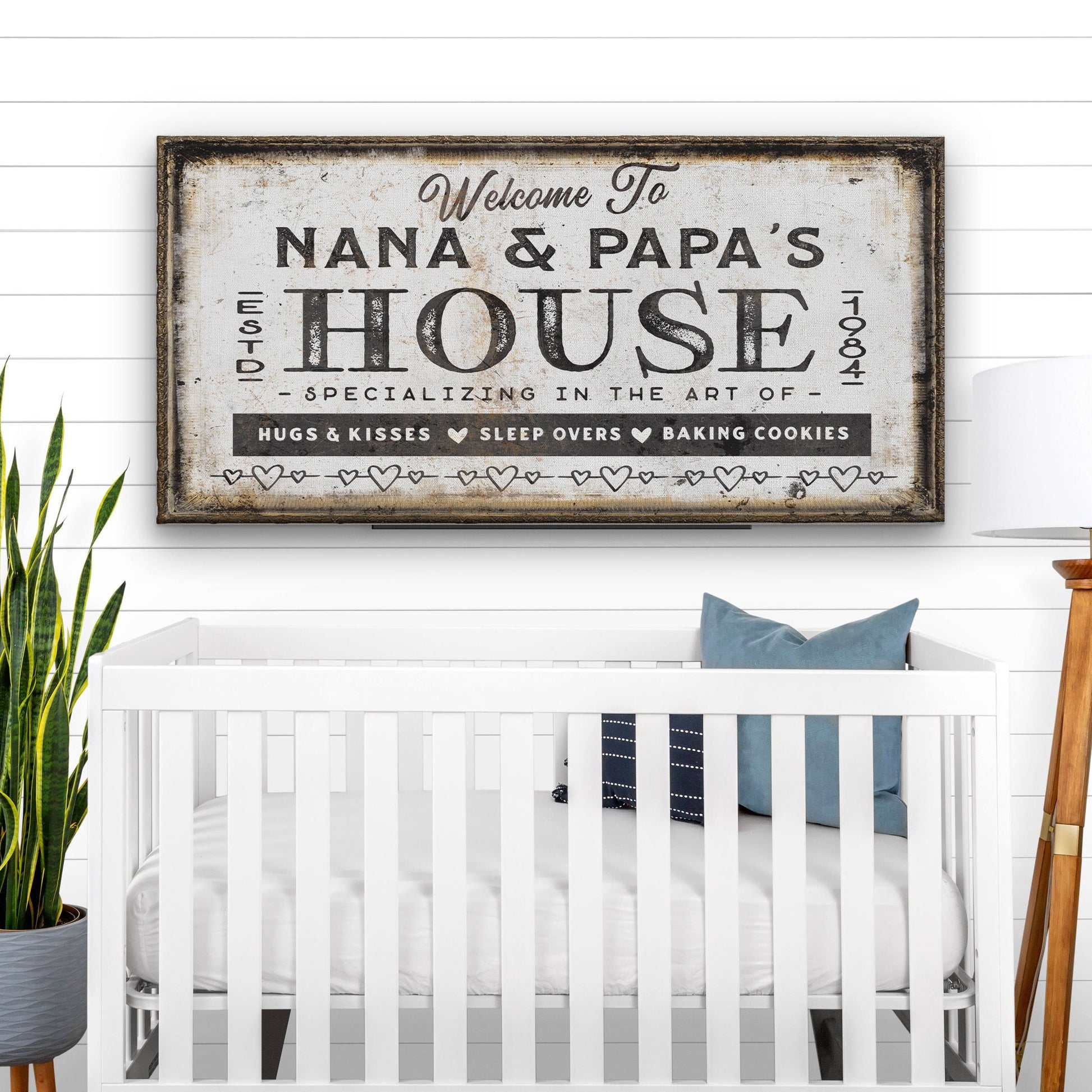 Grandparent welcome sign framed on white wall in bright living room setting