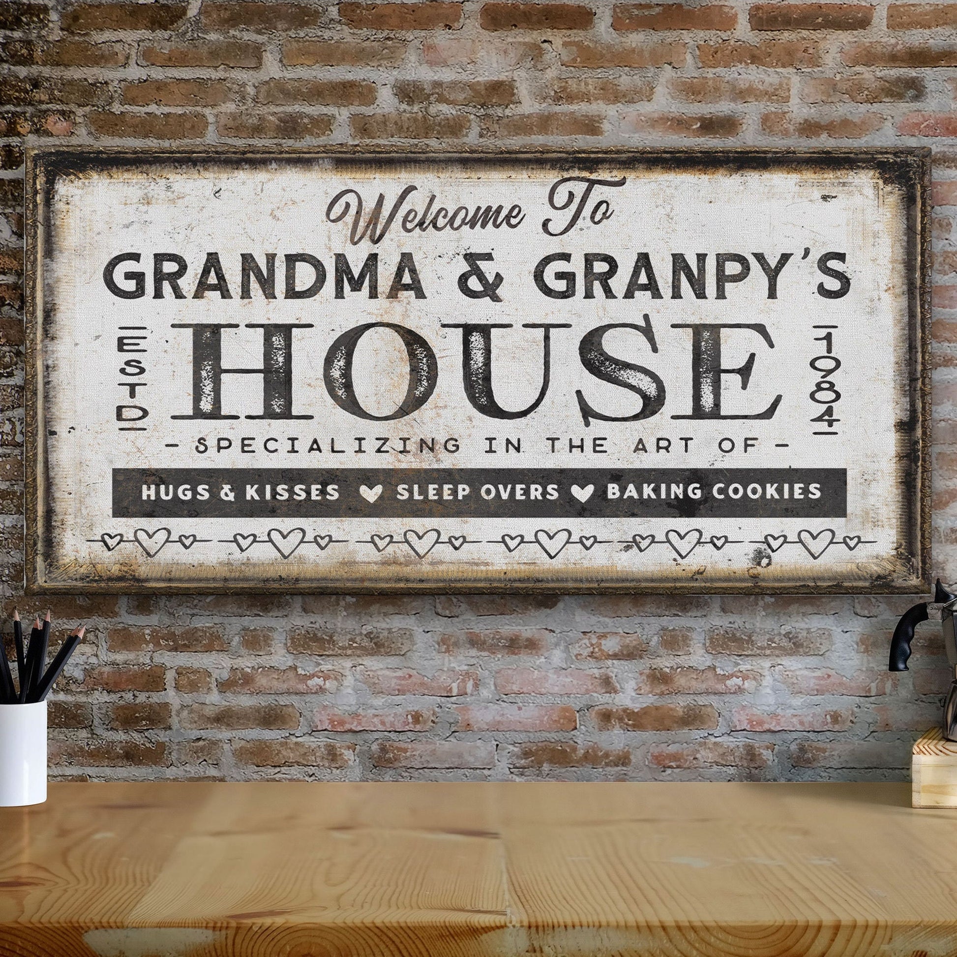Custom grandma and grandpas sign displayed above coastal sofa with blue throw pillow