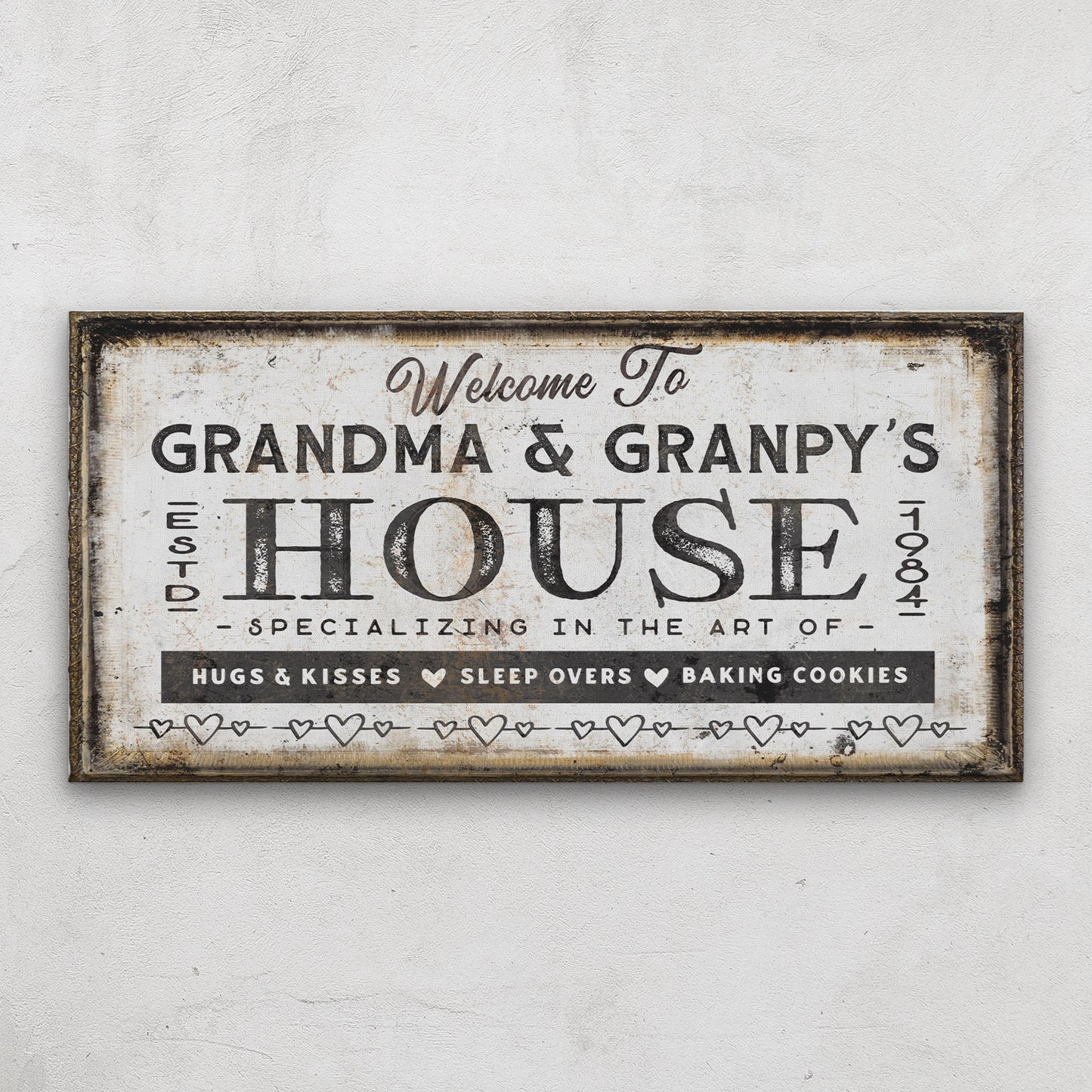 Custom grandparent welcome canvas displayed in living room corner with soft blue accent tones
