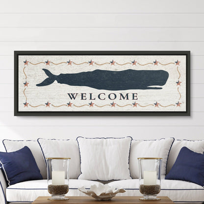 Framed whale canvas displayed above sofa in living room as coastal blue accent wall art