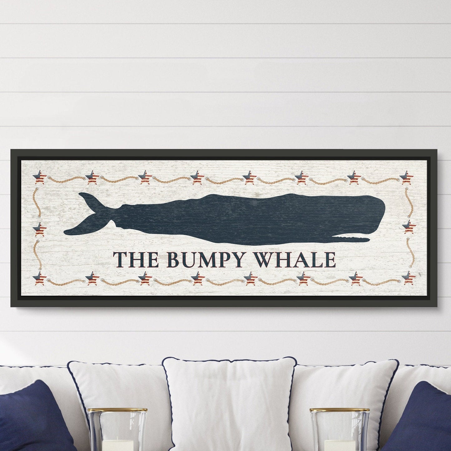 Custom framed whale canvas in beach house entryway with welcoming coastal art and wooden furniture