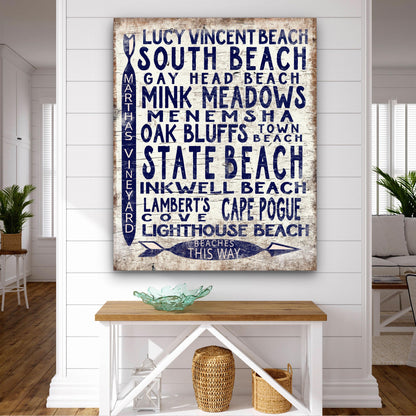 Beach destination sign displayed above console table with coastal home styling accessories